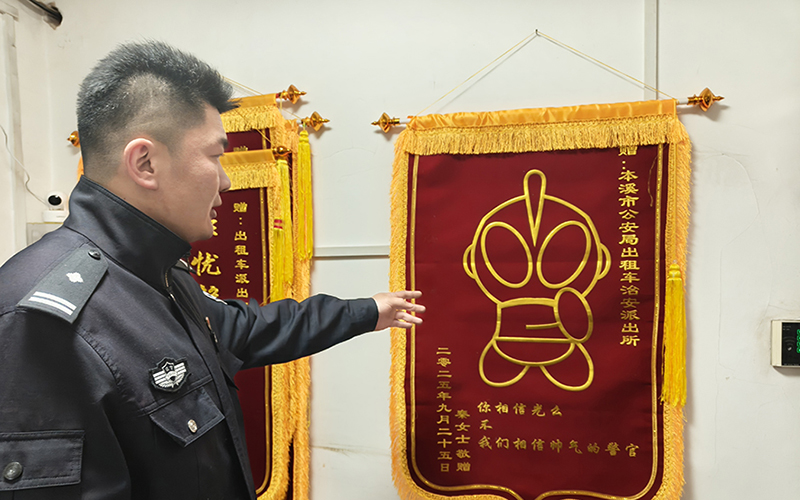 孟慶為向記者講述奧特曼錦旗的來歷